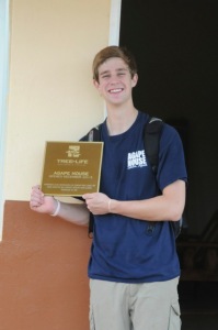 Colton holding the Agape House plaque that will adorn the wall next to the front door